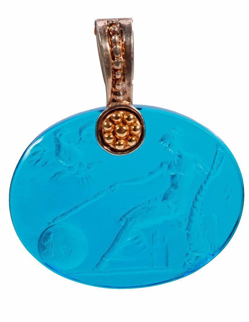 Italian Tagliamonte glass, silver and 14k gold pendant: the cast blue glass intaglio cabochon of a Muse surmounted by a sterling silver and 14k gold bail; signed Tagliamonte 925 14k Italy; measuring 1 3/8 x 1 1/8 in.