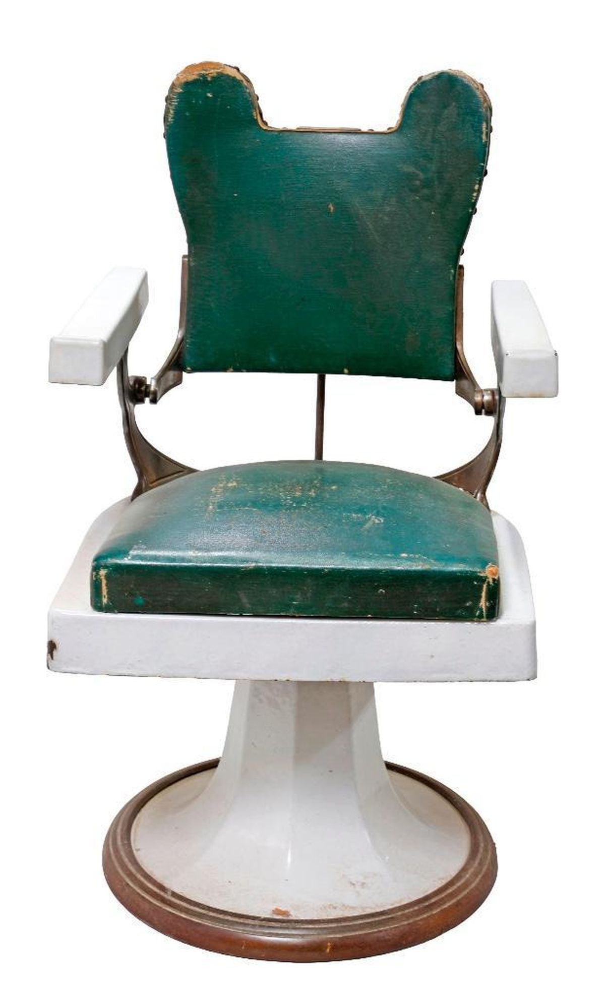 French Art Deco Barber's Chair: The white enamel chair having a green leather upholstered high back with Mickey Mouse ears, rising on stylized pedestal base, 38"h x 21"w x 23"d Provenance: Nest, San Francisco Condition: Overall worn