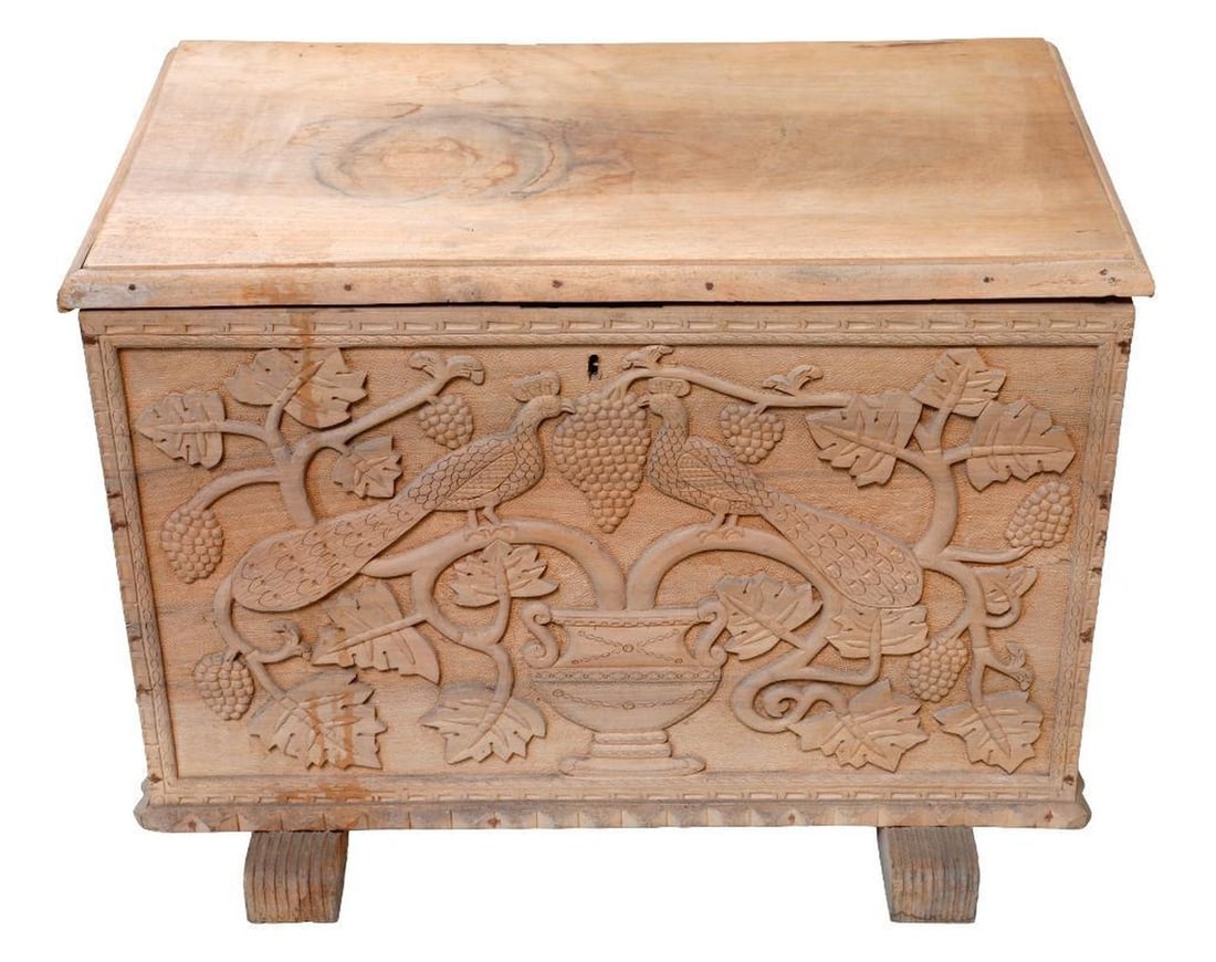 Folk Art Peacock Carved Wood Chest: Probably Indian, the lift top chest having a front panel depicting a pair of peacocks perched on a pair of ripe grape vines in an urn, carved in deep relief, 18.5"h x 25.5"w x 15.5"d