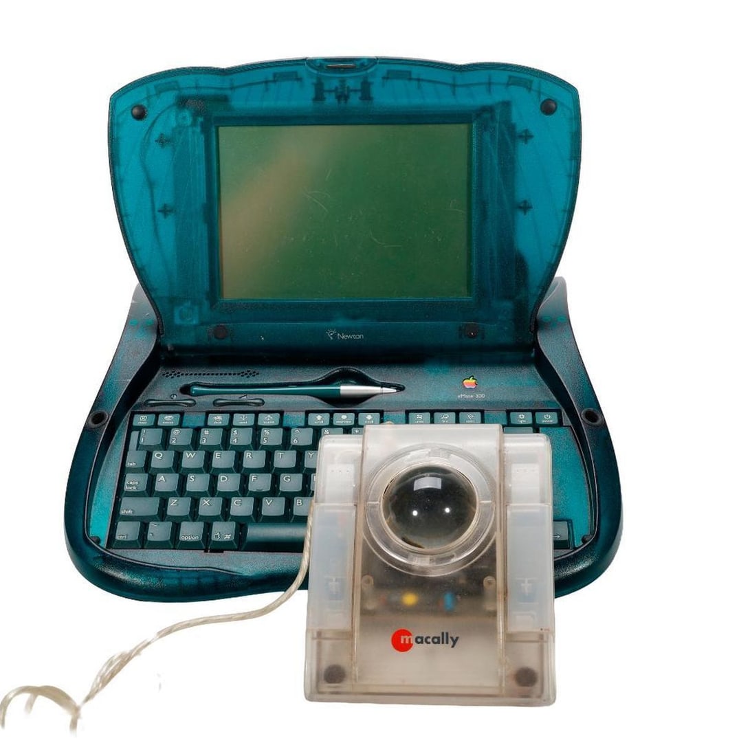 Apple eMate 300 Laptop, with Macally iBall: A circa 1997 Apple eMate 300 laptop, with translucent blue-green curved case, touchscreen, stylus pen, and Newton operating system. Approx. 9 3/4" x 11 3/4" (untested). Together with a Y2K transl