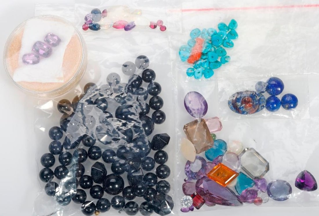 A miscellaneous group of unmounted stones: including opal, amethyst, sapphire, moonstone, quartz, lapis, onyx, cubic zirconia, spinel, topaz, synthetic ruby, coral, turquoise and glass; gross weight approximately 213 carats (excluding onyx wei