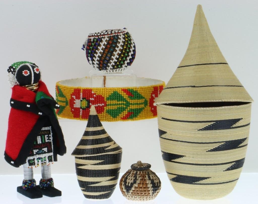 Collection of African items: Two Tutsi lidded baskets, a Ndebele doll, two other South African baskets and a headband. Turner Auctions + Appraisals is pleased to present basketry and other items from Native American and other ind