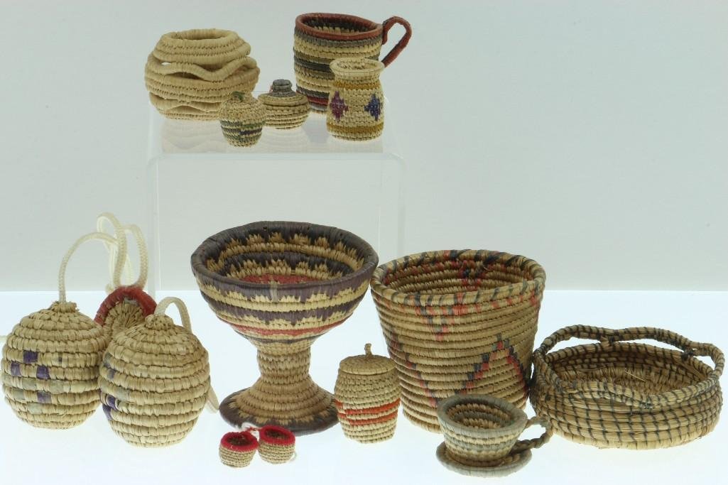 Collection of Eskimo miniature basketry items: Game balls, a coffee cup and more. Turner Auctions + Appraisals is pleased to present basketry and other items from Native American and other indigenous cultures from the private collection and estate