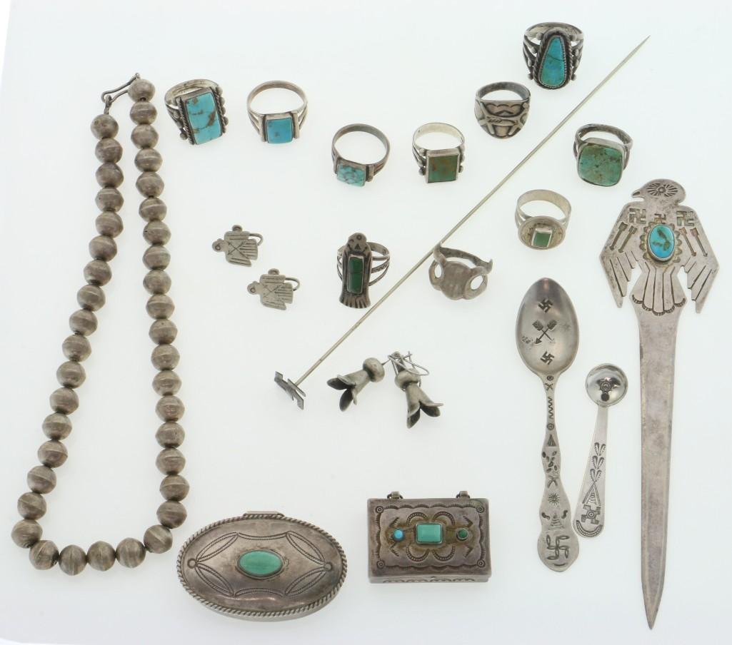 A collection of Southwest silver items: Mostly Navajo: eleven rings; two pairs of earrings; two pill boxes; two spoons; a letter opener; a hair pin; and a strand of beads. Turner Auctions + Appraisals is pleased to present