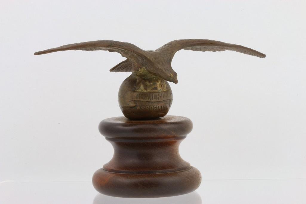 BRASS NATIONAL HIGHWAY COMMISSION EAGLE MASCOT: Wingspan: 7 inches Height: 4 1/4 inches Sy and Ronnie Margolis's eclectic collection features a wide range of hood or fender ornaments, from about 1909 to recent times. Most date from the 1920s and 19
