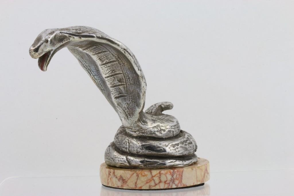 COBRA MASCOT, AEL: Height: 5 inches Sy and Ronnie Margolis's eclectic collection features a wide range of hood or fender ornaments, from about 1909 to recent times. Most date from the 1920s and 1930s, with many from the
