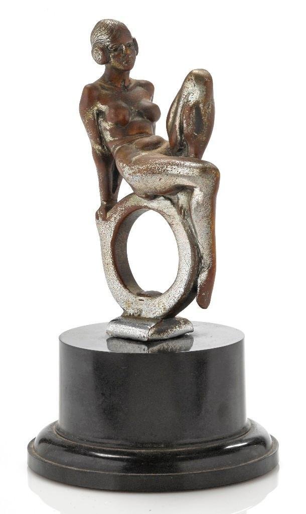 ART DECO LADY ON RING MASCOT: Height: 7 inches Sy and Ronnie Margolis's eclectic collection features a wide range of hood or fender ornaments, from about 1909 to recent times. Most date from the 1920s and 1930s, with many from the