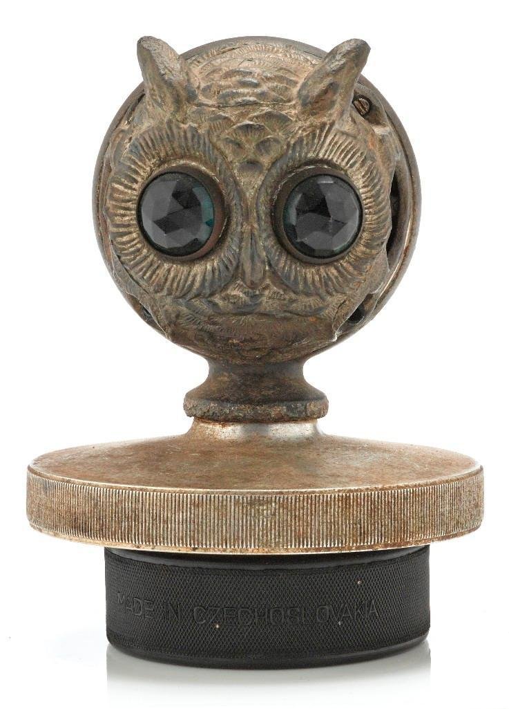MOTO GLOW OWLS HEAD MASCOT: Height: 5 1/4 inches Sy and Ronnie Margolis's eclectic collection features a wide range of hood or fender ornaments, from about 1909 to recent times. Most date from the 1920s and 1930s, with many from