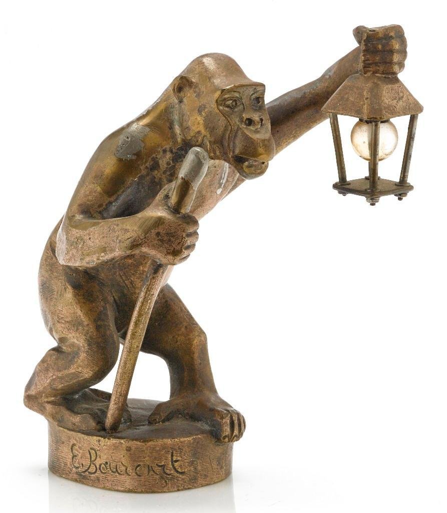 'APE WITH LIGHT' MASCOT BY E. BOURCART, 1920'S: Height: 5 1/2 inches Sy and Ronnie Margolis's eclectic collection features a wide range of hood or fender ornaments, from about 1909 to recent times. Most date from the 1920s and 1930s, with many from