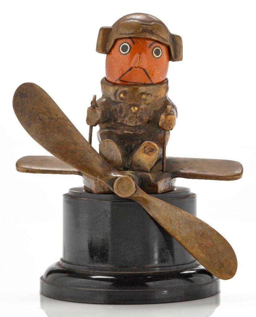 PILOT MASCOT BY H. HASSLE, BRITISH, 1921: Approximate height: 6 1/2 inches Sy and Ronnie Margolis's eclectic collection features a wide range of hood or fender ornaments, from about 1909 to recent times. Most date from the 1920s and 1930s, wi