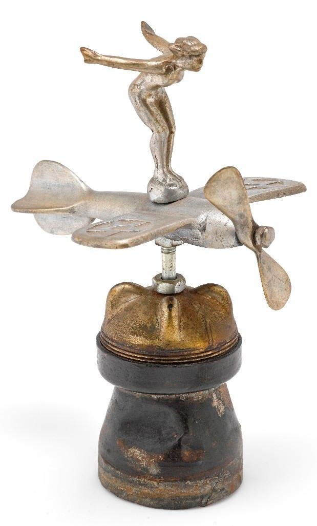 AMERICAN ACCESSORY AIRPLANE WITH WOMAN ON TOP: Height: 7 inches Sy and Ronnie Margolis's eclectic collection features a wide range of hood or fender ornaments, from about 1909 to recent times. Most date from the 1920s and 1930s, with many from the