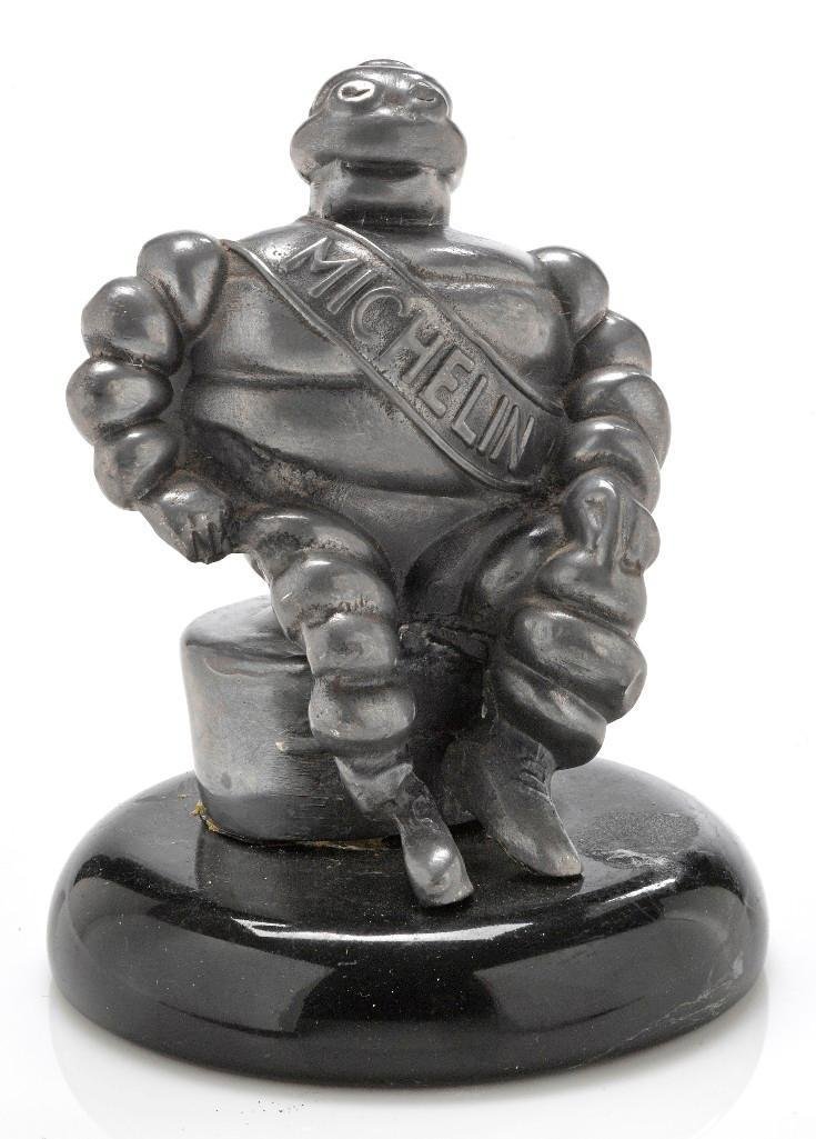 A CAST REPRODUCTION OF THE MICHELIN BIBENDUM: Height: 4 1/2 inches Sy and Ronnie Margolis's eclectic collection features a wide range of hood or fender ornaments, from about 1909 to recent times. Most date from the 1920s and 1930s, with many from