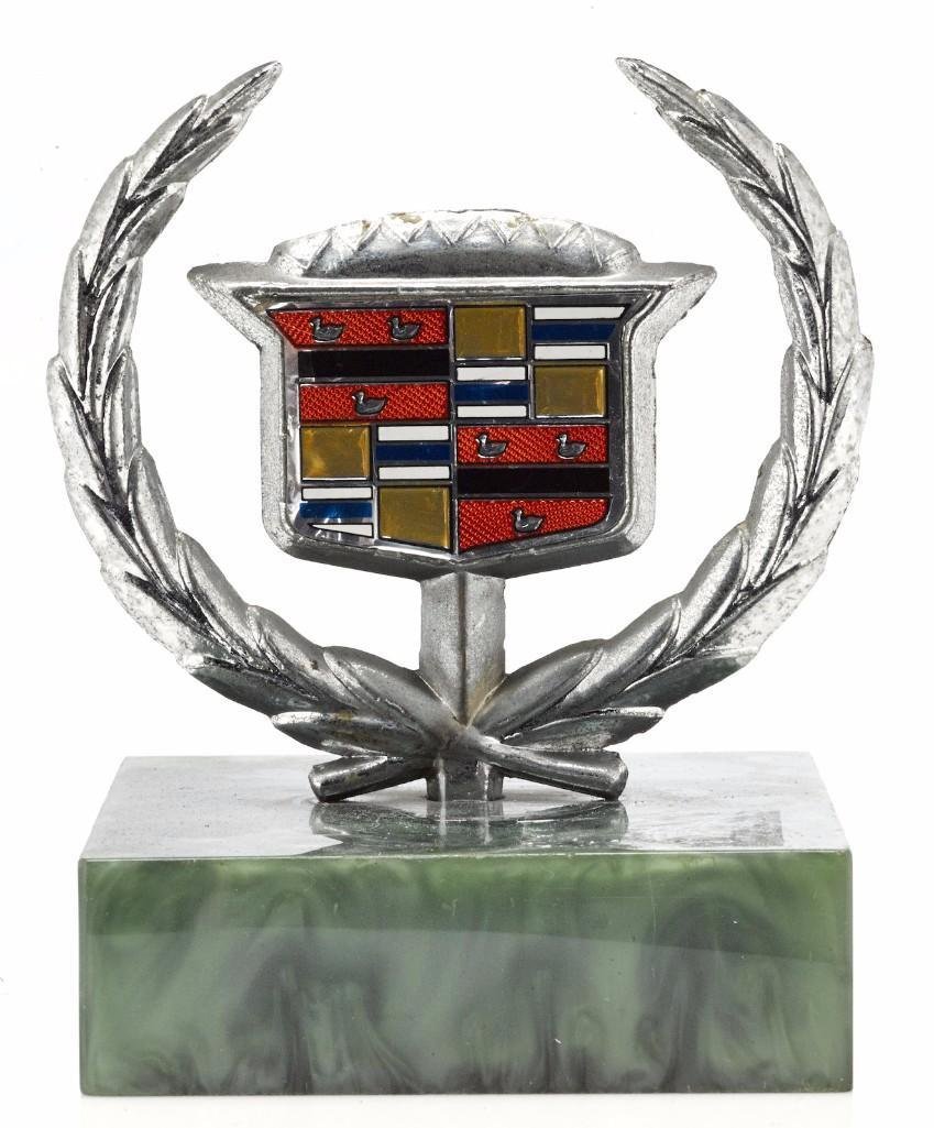 CADILLAC EMBLEM, 1970'S: Height: 4 inches Sy and Ronnie Margolis's eclectic collection features a wide range of hood or fender ornaments, from about 1909 to recent times. Most date from the 1920s and 1930s, with many from the
