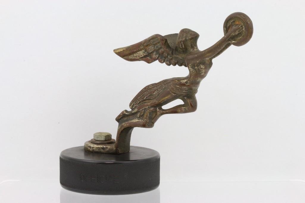 AFTER MARKET WINGED LADY MASCOT SIMILAR TO PACKARD: Possible pedal car mascot Length of mascot: 6 inches Sy and Ronnie Margolis's eclectic collection features a wide range of hood or fender ornaments, from about 1909 to recent times. Most date from the