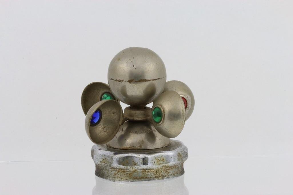 AMERICAN JEWELED ACCESSORY ACTION MASCOT, 1925: Dented on top Height: 3 1/2 inches Sy and Ronnie Margolis's eclectic collection features a wide range of hood or fender ornaments, from about 1909 to recent times. Most date from the 1920s and 1930s, 