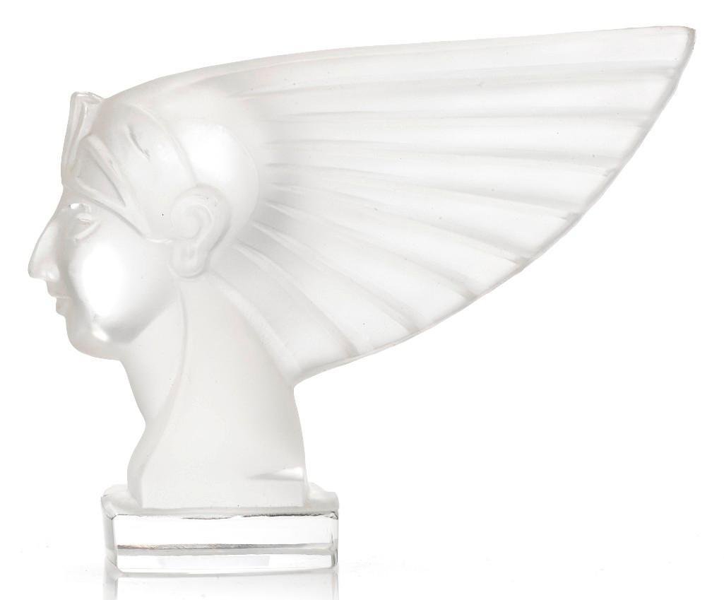RED ASHEY RA GLASS MASCOT: Height: 5 inches Length: 6 1/2 inches Sy and Ronnie Margolis's eclectic collection features a wide range of hood or fender ornaments, from about 1909 to recent times. Most date from the 1920s and 1930