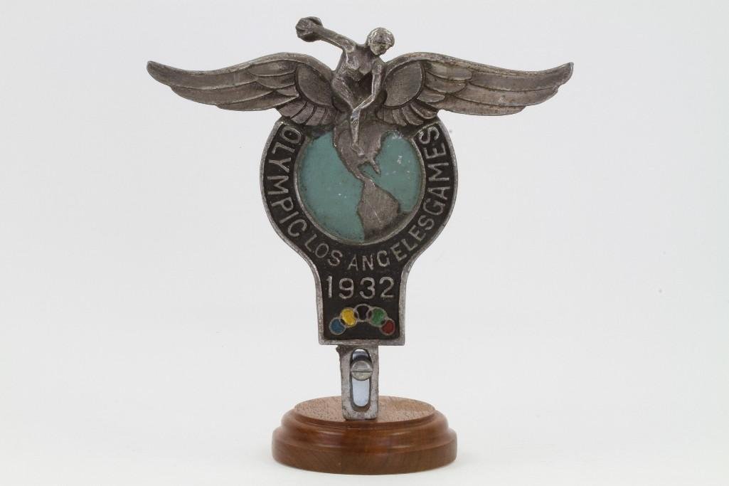 1932 LOS ANGELES OLYMPICS GRILLE BADGE: Design Patent applied for 1932 Height without base: 6 1/2 inches Note: The sale features 110 lots related to the 1932 Olympics in Los Angeles, including car mascots, radiator badges, license plates, b