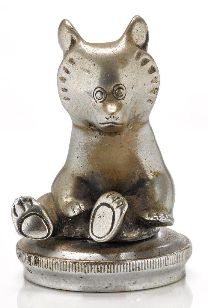 HONEY BEAR MASCOT: Height: 4 1/2 inches Note: The sale features 110 lots related to the 1932 Olympics in Los Angeles, including car mascots, radiator badges, license plates, banners, maps, pennants, booklets, tickets an
