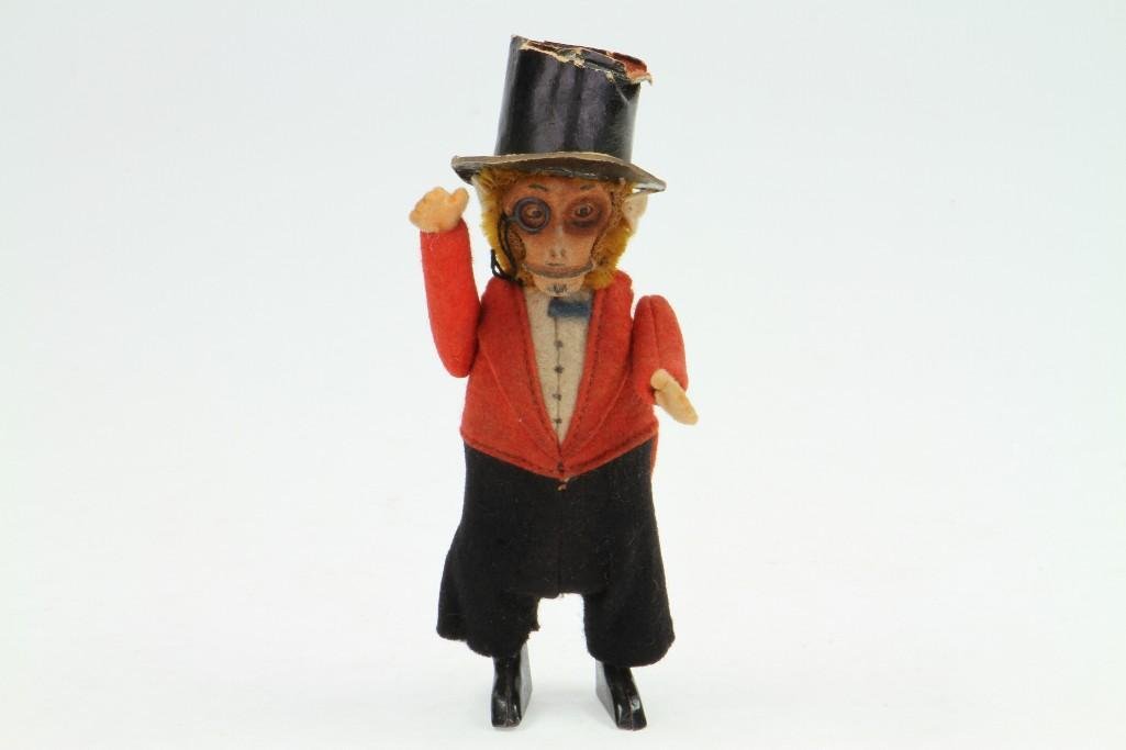 Schuco Articulated Gentleman Monkey: 1929; Tin Construction with Original Clothing (Damage to Top Hat); Good Condition, 6"H Notes:Turner Auctions + Appraisals is pleased to feature the Anita & Sedwick Hellman Toy Collection. Offerin