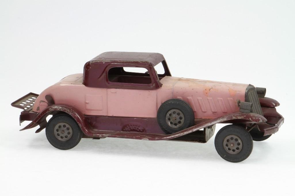 Girard Coupe: Painted Pressed Steel in (2) Tone Purple, Good Tires; Clockwork Mechanism, Battery Box Damage; Good Condition, 14 1/2"L Notes:Turner Auctions + Appraisals is pleased to feature the Anita & Sedwic