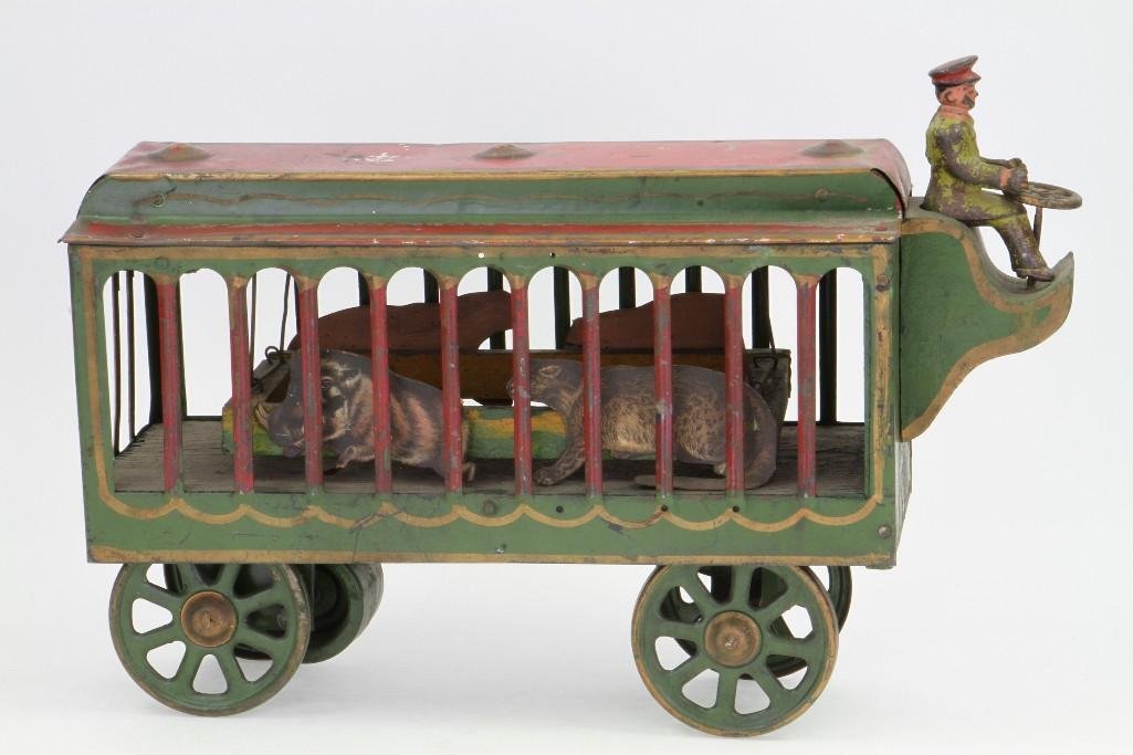 Motorized Circus Animal Cage: Hand Painted Pressed Steel/Wood/Cast Iron Construction, Original Card Stock Litho Animals; Clockwork Mechanism, Needs Cleaning; Excellent Condition, 10"H x 14 1/2"L Notes:Turner Auctions + A