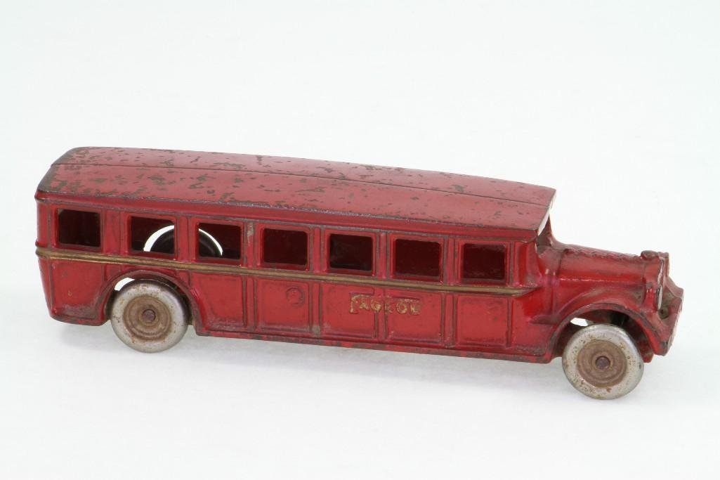 Arcade Fageol Bus: Painted Cast Iron in Red with Gold Stripes, Nickel Wheels; Very Good Condition, 8"L Notes:Turner Auctions + Appraisals is pleased to feature the Anita & Sedwick Hellman Toy Collection. Offering o
