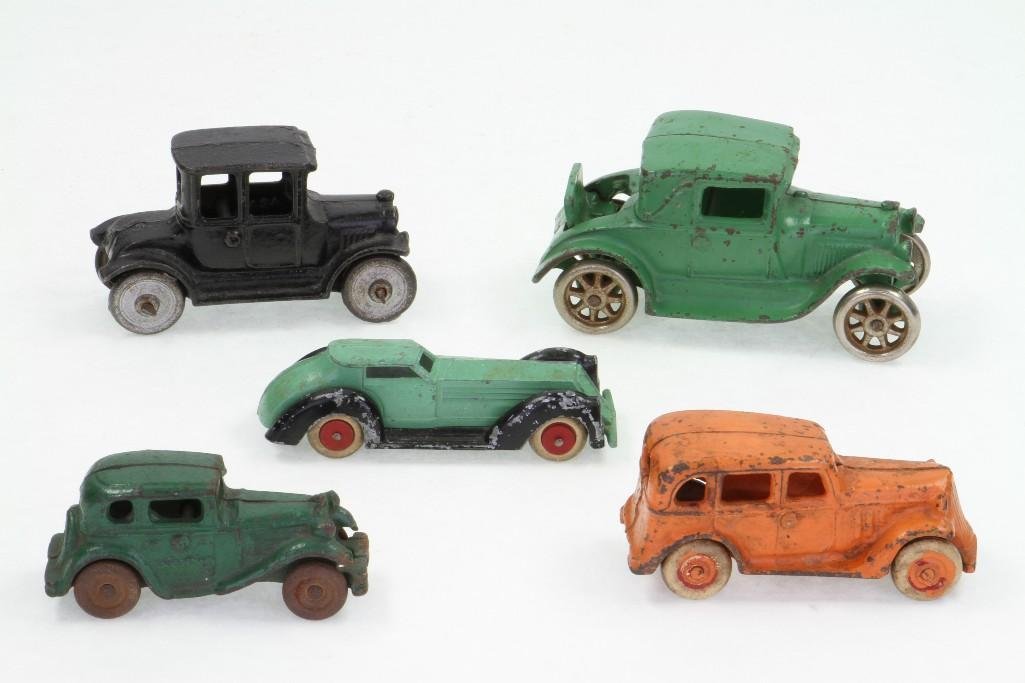 Coupe and Sedan Autos: Mixed Makers, Including Arcade; (4) Each Painted Cast Iron, (1) Diecast Deco Coupe; Good To Very Good Condition, 3 3/4" - 4 1/2"L Notes:Turner Auctions + Appraisals is pleased to feature the