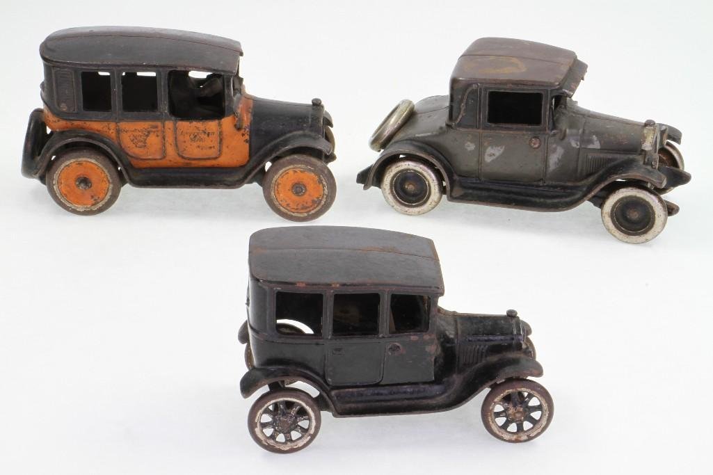 1920's Automobiles: Arcade; Painted Cast Iron; (1) Buick Coupe with Nickel Wheels, (1) Model T Sedan (Missing Driver), (1) Yellow Cab; Fair to Good Condition, 6 1/2" - 7 1/2"L Notes:Turner Auctions + Appraisals
