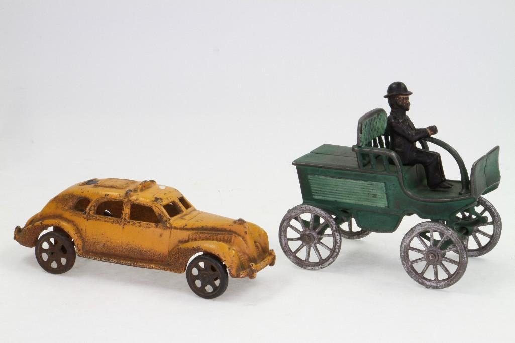 Two Toy Automobiles: Painted Cast Iron; An Early Run About with Driver, the Other a Yellow Taxi (Believe to be a Reproduction); Poor Condition, 6" - 8"L Notes:Turner Auctions + Appraisals is pleased to feature t