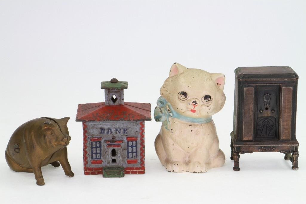 (4) Still Banks: Includes Hubley Kitten, J&E Stevens Cupola Building Bank, AC Williams Seated Pig and Cast Iron Bronze Radio (Unknown Maker); Good to Very Good Condition, 3 1/4" x 5"L Notes:Turner Auctio