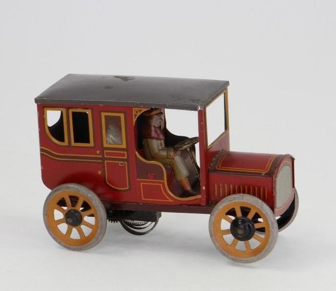 Bing Limo withDriver: Tin Lithograph; Clockwork Driven, Adjustable Steering; As New Condition, 5 1/4"L Notes:Turner Auctions + Appraisals is pleased to feature the Anita & Sedwick Hellman Toy Collection. Offering over