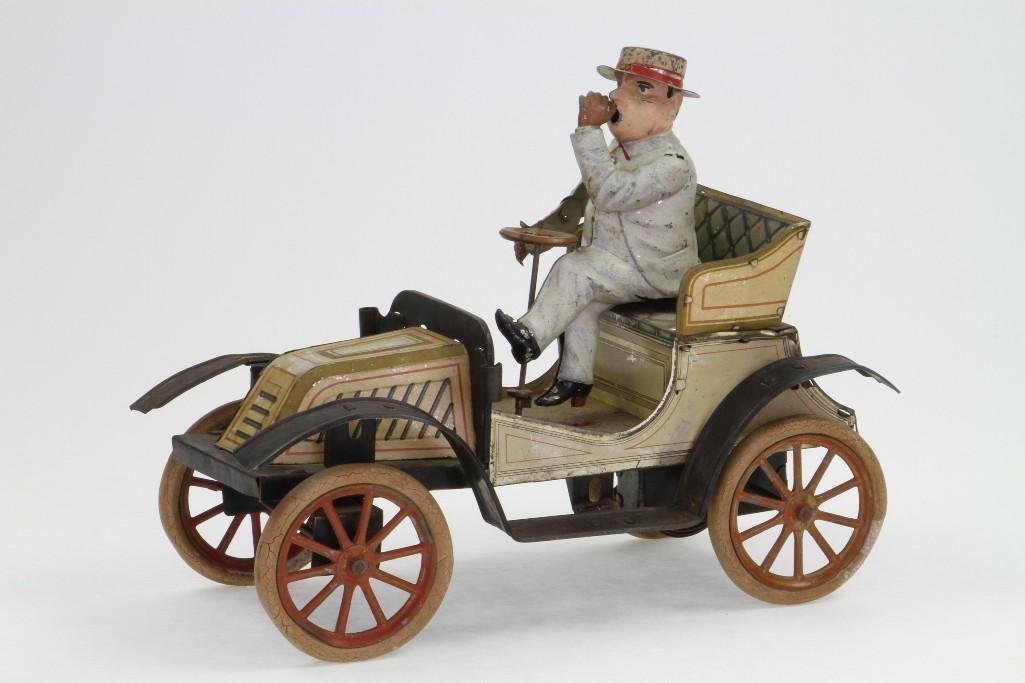 Early Carette Roadster: Lithograph Tin Construction, Original Except Incorrect Driver (Tut-Tut), Missing Lamps, Damage to Litho on Hood, Needs Cleaning, Clockwork Mechanism; Ovrall Good Condition, 10 1/2"L Notes:Turner 