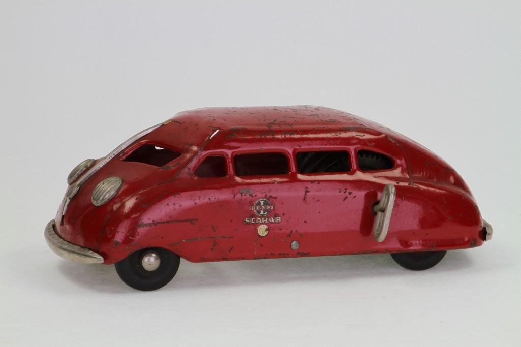 Scarab Automobile: Buddy L; Painted Presses Steel, Decal Graphics, Rubber Tires, Clockwork Powered; Very Good Condition, 10 1/2"L Notes:Turner Auctions + Appraisals is pleased to feature the Anita & Sedwick Hellman