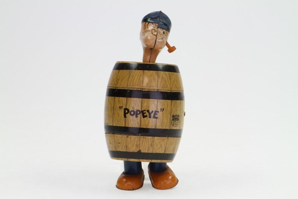 Popeye in a Barrel: Chein, Tin Lithograph, Clockwork Action; Excellent Condition, 7 1/2"H Notes:Turner Auctions + Appraisals is pleased to feature the Anita & Sedwick Hellman Toy Collection. Offering over 245 lots a