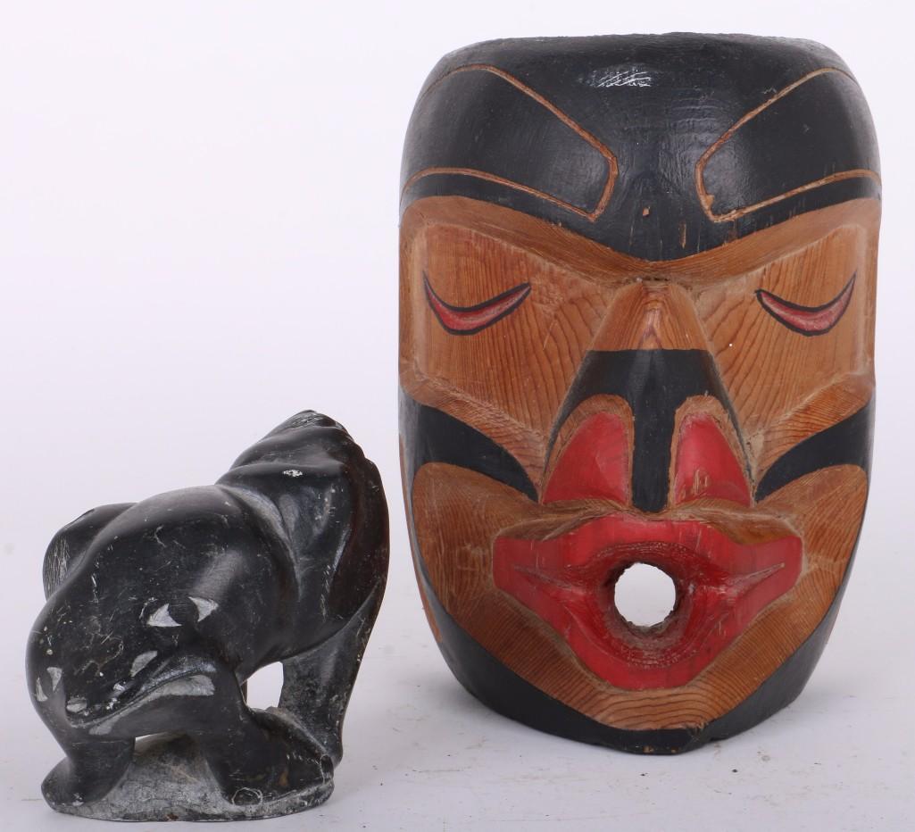 Two Northwest items: A Kwakiutl mask of "Wild Woman", by (illegible first name) Hunt; and an Inuit soapstone figure of a fantastic composite creature, signed on the base: Petar Nauya Largest example height: 6 1/