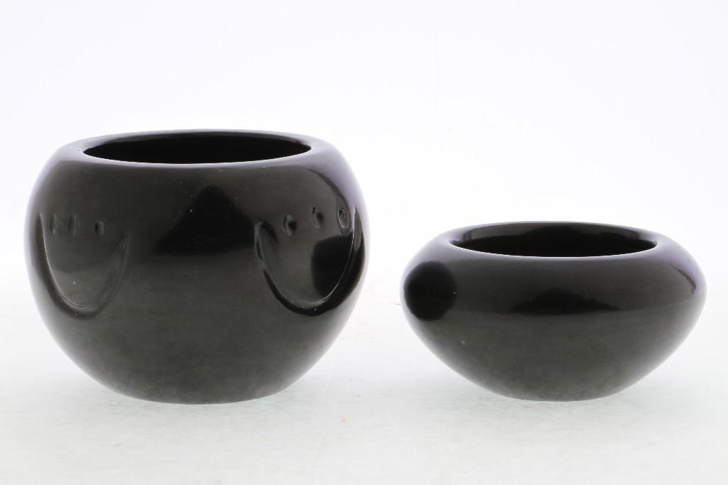 Two Santa Clara blackware bowls: A bear-paw example, Mela Youngblood, and a smaller bowl, Nathan Youngblood Largest example: 3 1/2 x 5 inches Provenance: Turner Auctions + Appraisals is pleased to offer the library and selected artif