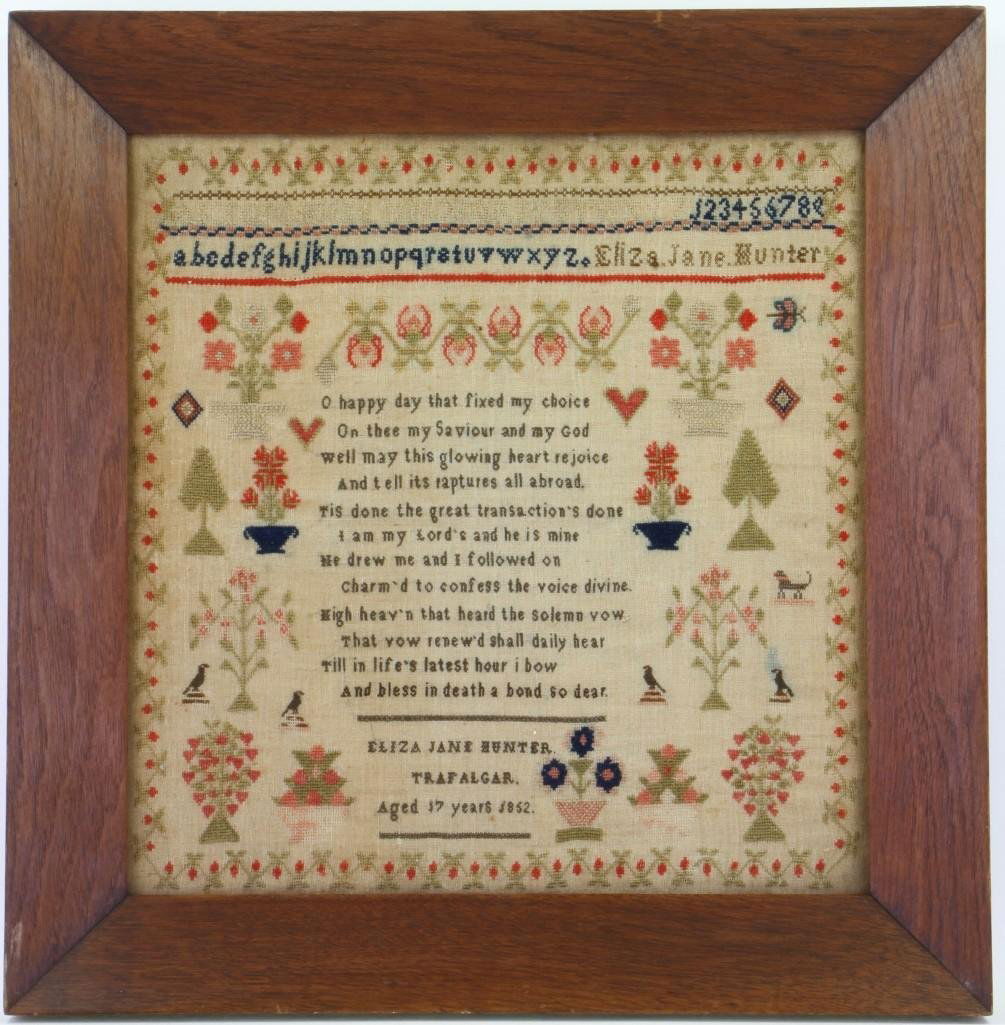 A wool and linen needlework sampler, 1852: A wool and linen needlework sampler English, Eliza Jane Hunter, dated 1852 Centering rows of the alphabet and numbers above a verse surrounded by stylized floral baskets, birds, animals, hearts, butte