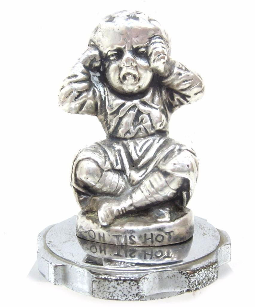 "OH TIS HOT" MASCOT BY J. REEVES, 1924: Height: 4 inches Notes:This "Fine Mélange" comes from numerous sources and estates. Here are just some of items this sale includes: charming Steiff animals (over 40 lots of almost 150 items), Louis V