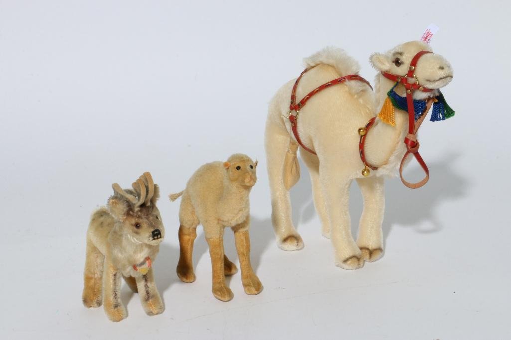THREE STEIFF ANIMALS: Two camels and one vintage reindeer Notes:This "Fine Mélange" comes from numerous sources and estates. Here are just some of items this sale includes: charming Steiff animals (over 40 lots of almost 