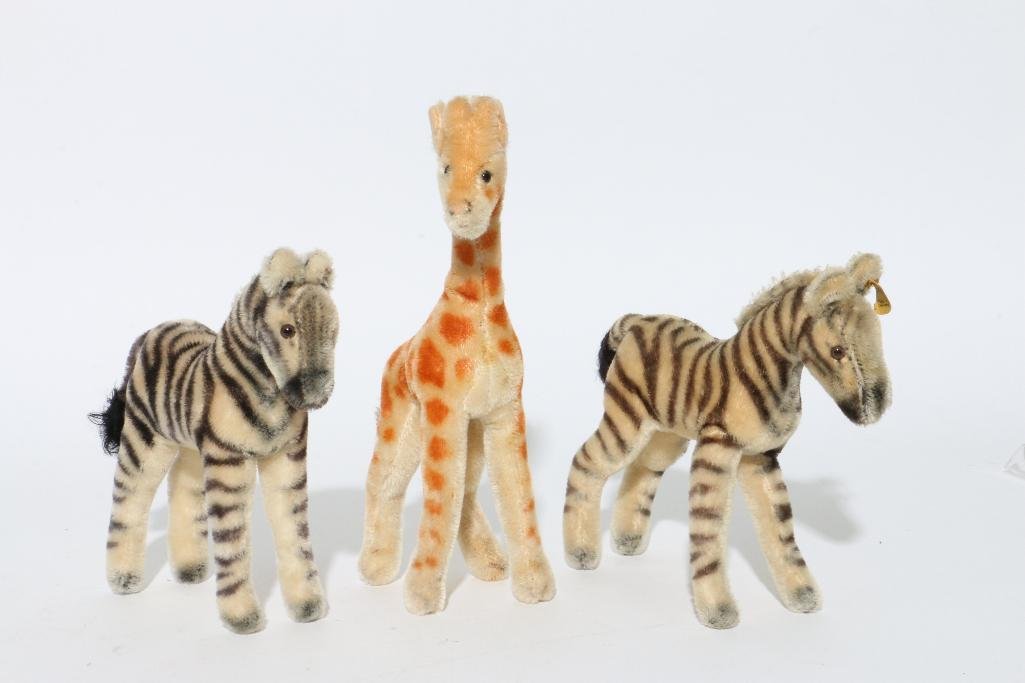 THREE STEIFF ANIMALS: One Steiff giraffe and two Steiff zebras Notes:This "Fine Mélange" comes from numerous sources and estates. Here are just some of items this sale includes: charming Steiff animals (over 40 lots 