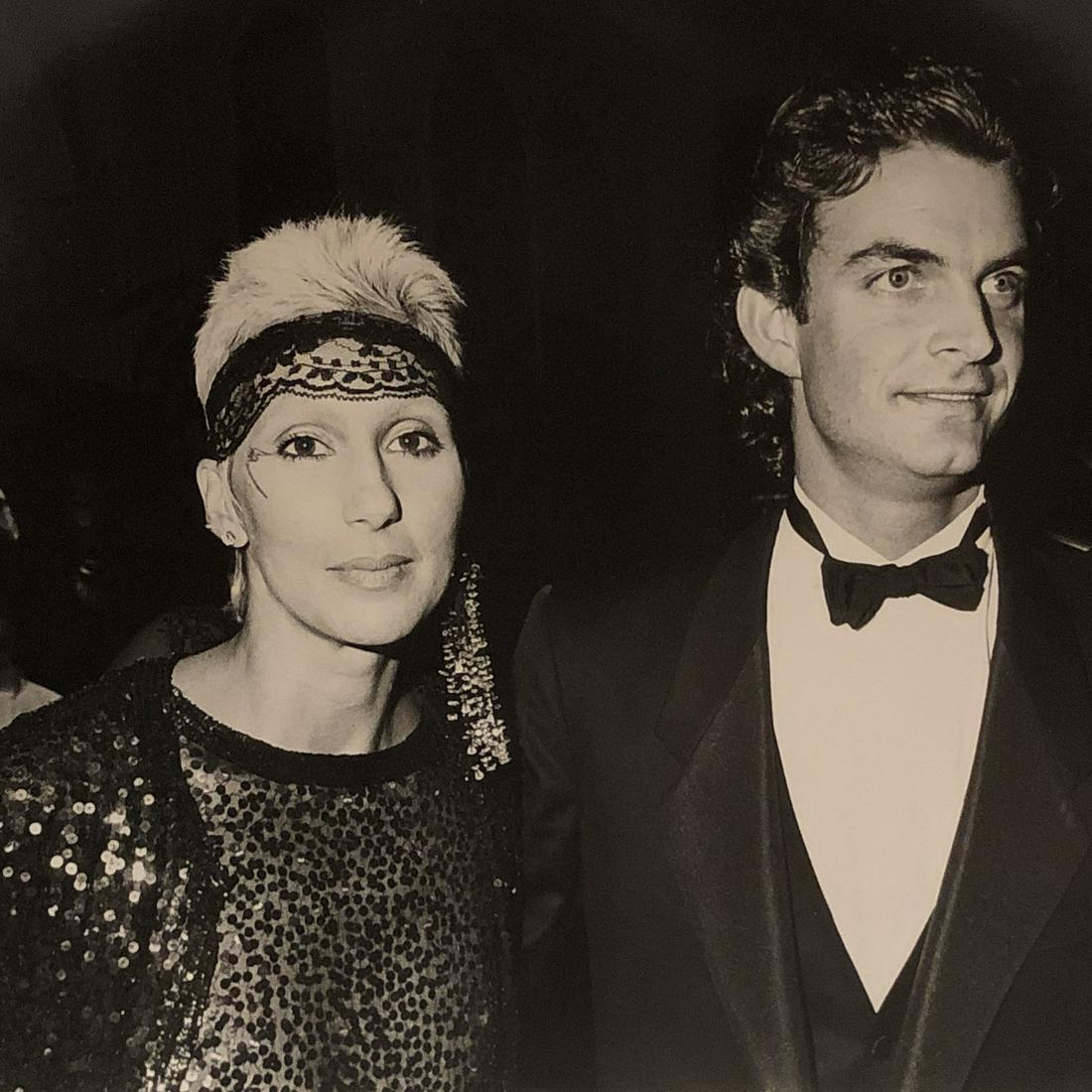 Cher and date Josh Donen at Aaron Spelling party 1984: Taken Sept 30, 1984 by noted photographer Barry King w/ photographer stamp and description verso. 9x7 on Kodak paper.