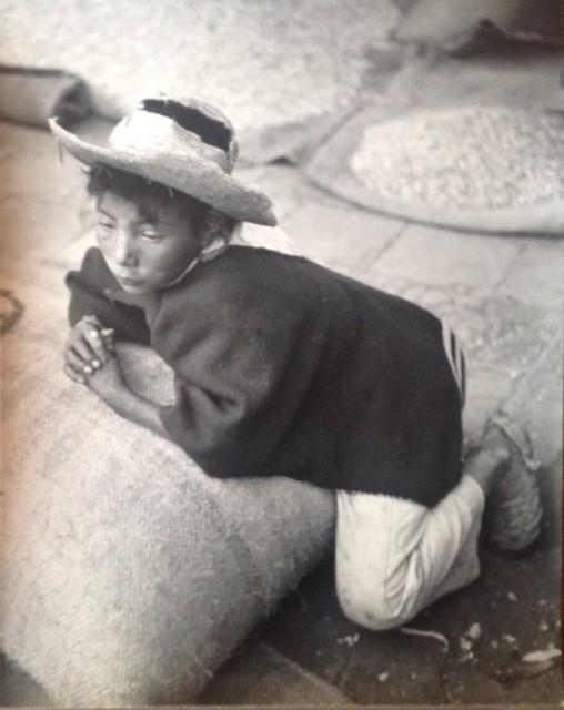 Marguerite Baker Johnson - Boy leaning on a bag of corn: Photographer: Marguerite Baker Johnson Black and White Vintage Mid Century Photograph Dimensions: 13 1/2 x 10 1/2 Scene: Boy in Straw Hat Verso: studio stamp plus hand written notes of location in pen