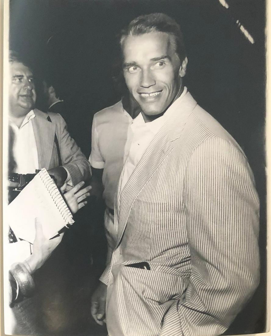 Arnold Schwarzenegger at premier of "Aliens" 1986: Taken July 14, 1986 by noted photographer Steve Granitz w/ photographer stamp and description verso. 9x7 on Kodak paper.