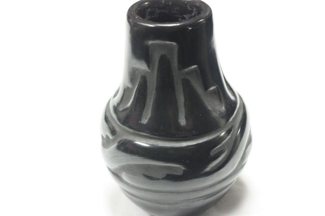 Santa Clara Pueblo Pottery Vase signed by Celes Aguilar: A beautiful handmade bowl by Celes Aguilar of the Santa Clara Pueblo, one of the famous families of potters in the region of New Mexico. This vase measures at four inches (4") at its widest point and 