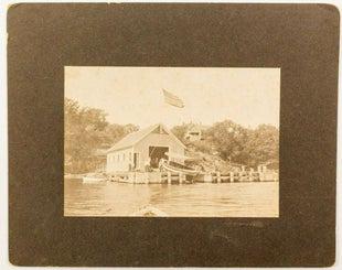 Massachusetts Boathouse Photo: Choice vintage photo of a boat on a boathouse ramp in Massachusetts, 42 star US flag. By JR O'Hara, Jr. in Winthrop, Mass. Photo is 4.5" x 6.5", matting 8" x 10". State: Massachusetts City: Date: 1899