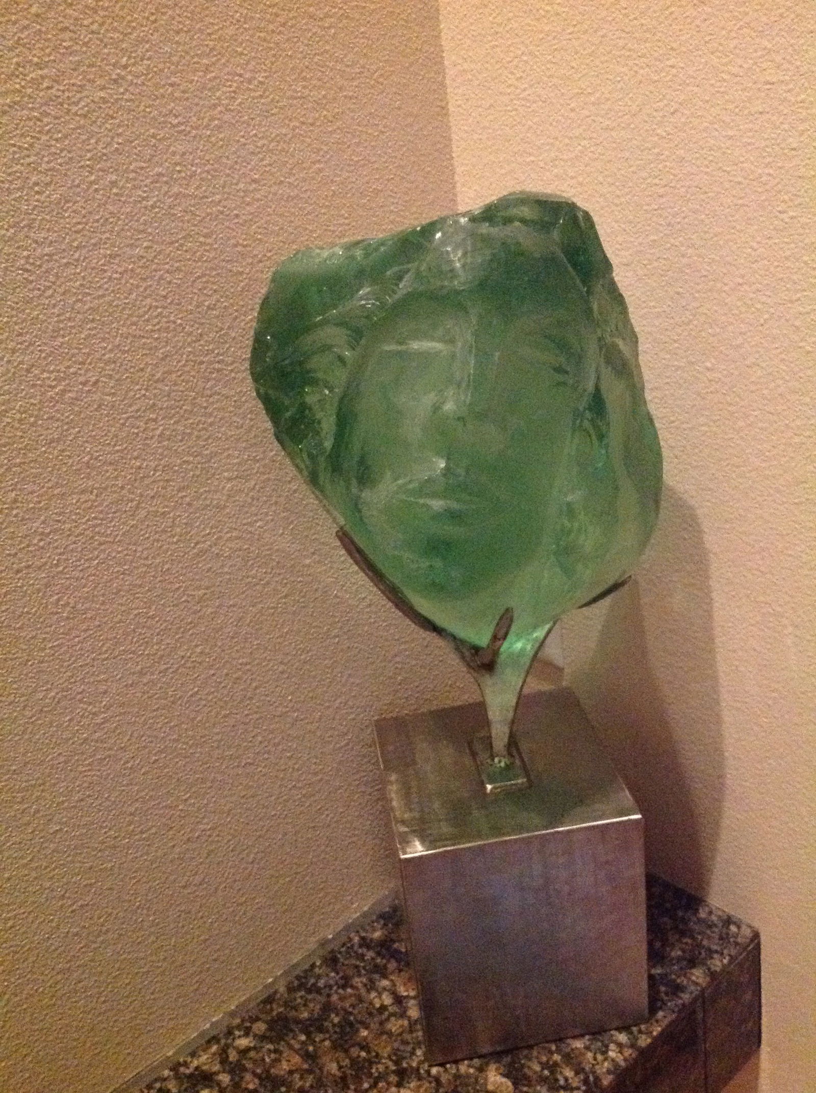 Suzanne Regan Pascal (b. 1914) American - Glass Sculpture: Suzanne Pascal - "Head of a Woman" Carved, chiseled and Polished Green Slag Glass. Inscribed Signature lower right. Sculpture Height: 17" Fitted on artist custom created metal based designed