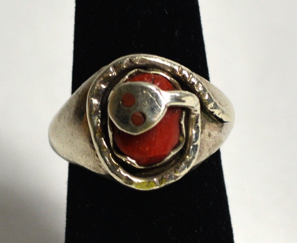 Sliver Old Antique Coral Ring: Sliver old antique ring with coral and snake around the coral it has the artist sign in the back of the ring.