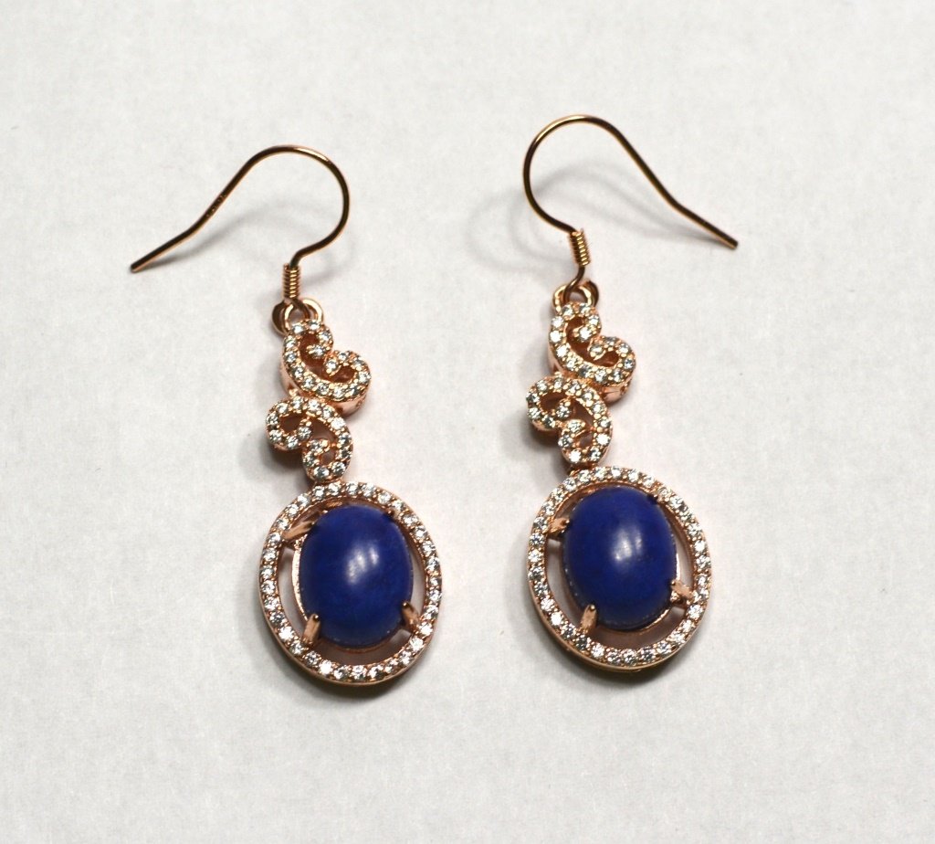 Pair Of Natural Lapis Lazuli Ear Rings: Pair of natural lapis lazuli ear rings surrounded by diamonds.