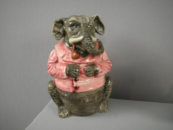 Majolica humidor of elephant with red smoking jack: Majolica humidor of elephant with red smoking jacket, 8", repair to elephant's trunk