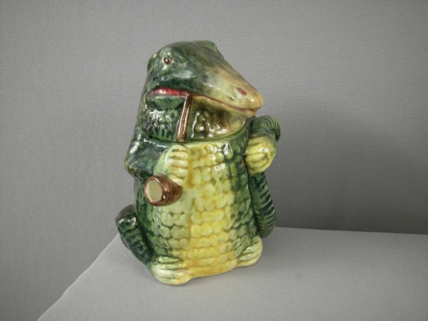 Majolica humidor of aligator with pipe, rim chip a: Majolica humidor of aligator with pipe, rim chip and hairline to base, 6 1/2"